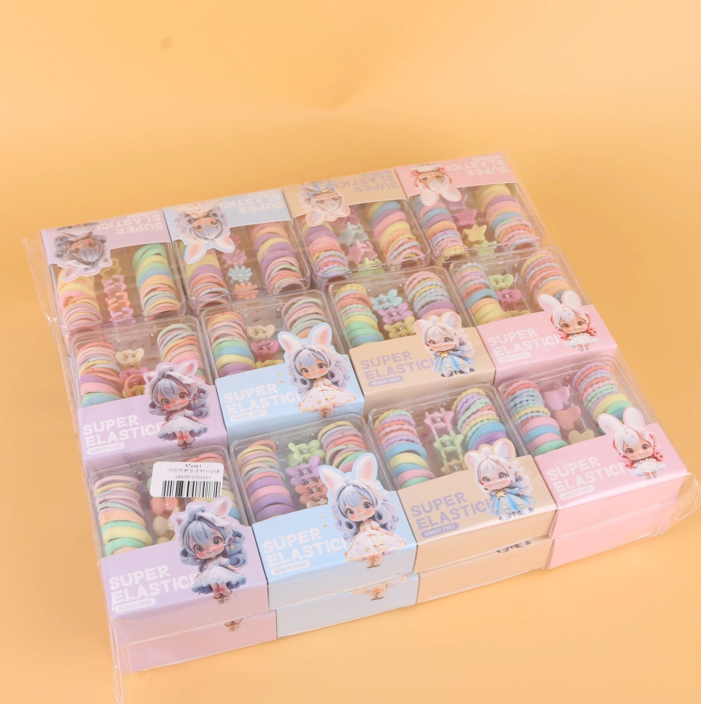 fondo tomate con Ligas elásticas de colores en caja cuadrada pequeña, resistentes y prácticas. Se venden al por mayor para tiendas y distribuidores.