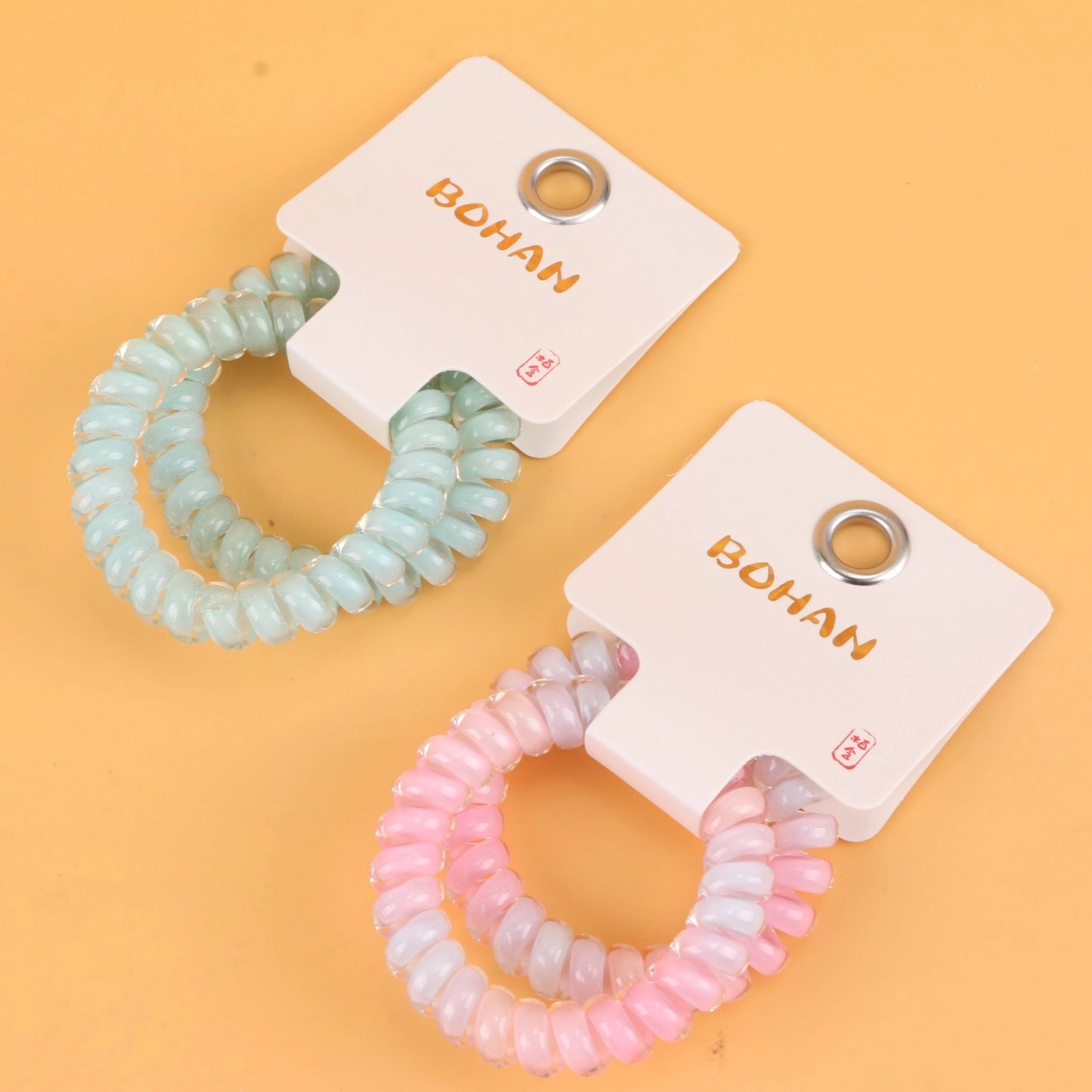 fondo tomate con Ligas para el cabello en espiral tipo cable telefónico, resistentes y coloridas. Ligero set de 21 g, ideal para mayoristas y tiendas de accesorios.